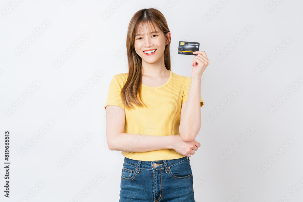 Cheerful beautiful Asian woman holding mockup credit card isolated on white background. Cheerful beautiful Asian woman holding mockup credit card isolated on white background.