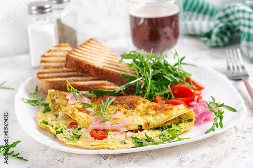 Healthy breakfast. Omelette with cheese, tomatoes   and green herbs. Omelette, salad and toast. Keto, ketogenic lunch.