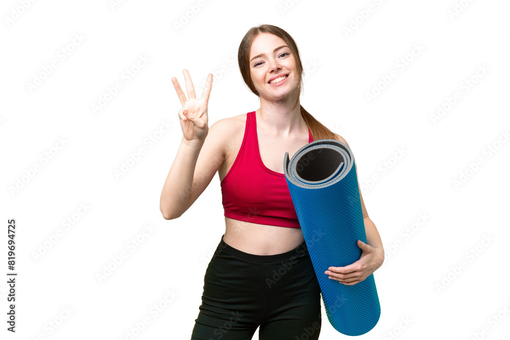 Young sport woman going to yoga classes while holding a mat over isolated chroma key background happy and counting three with fingers Young sport woman going to yoga classes while holding a mat over isolated chroma key background happy and counting three with fingers