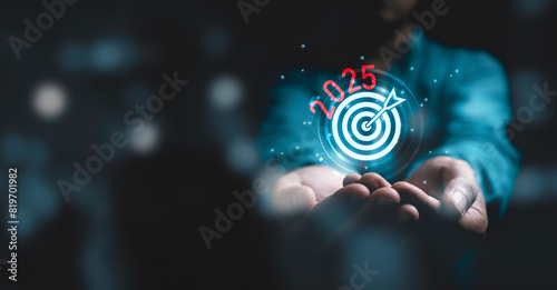 Businessman holding glowing 2024 with dartboard and arrow for setup new business objective target and goal  since new year concept , Happy new year and merry Christmas concept.