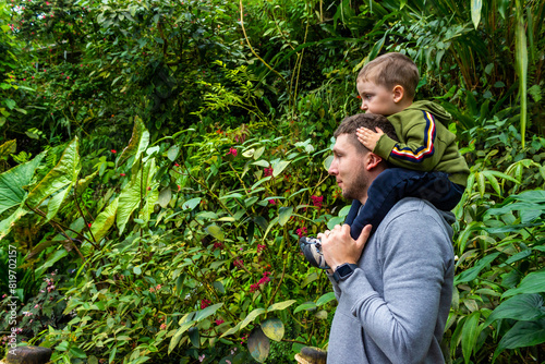 Father and son visit the botanical garden's tropical greenhouse