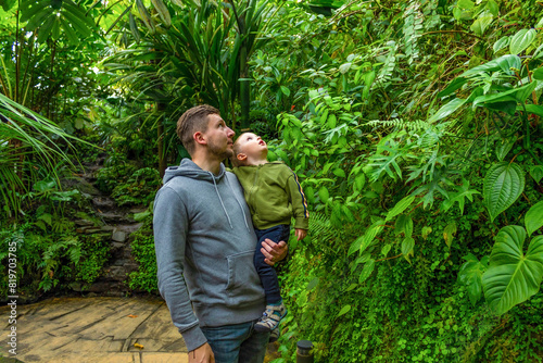 Father and son visit the botanical garden's tropical greenhouse