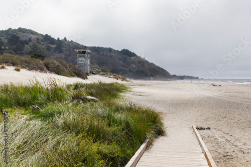 foggy Stinson beach at morning with a changing room in front of grassland photo