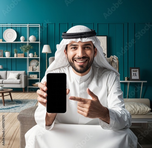 A Saudi character young man holding a phone sitting in the armchair on home