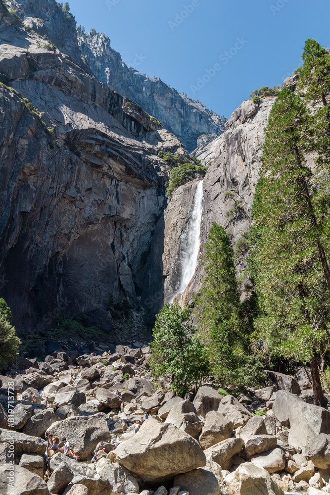 view through the trees to the famous lower Yosemite fall from below at the Yosemite national park