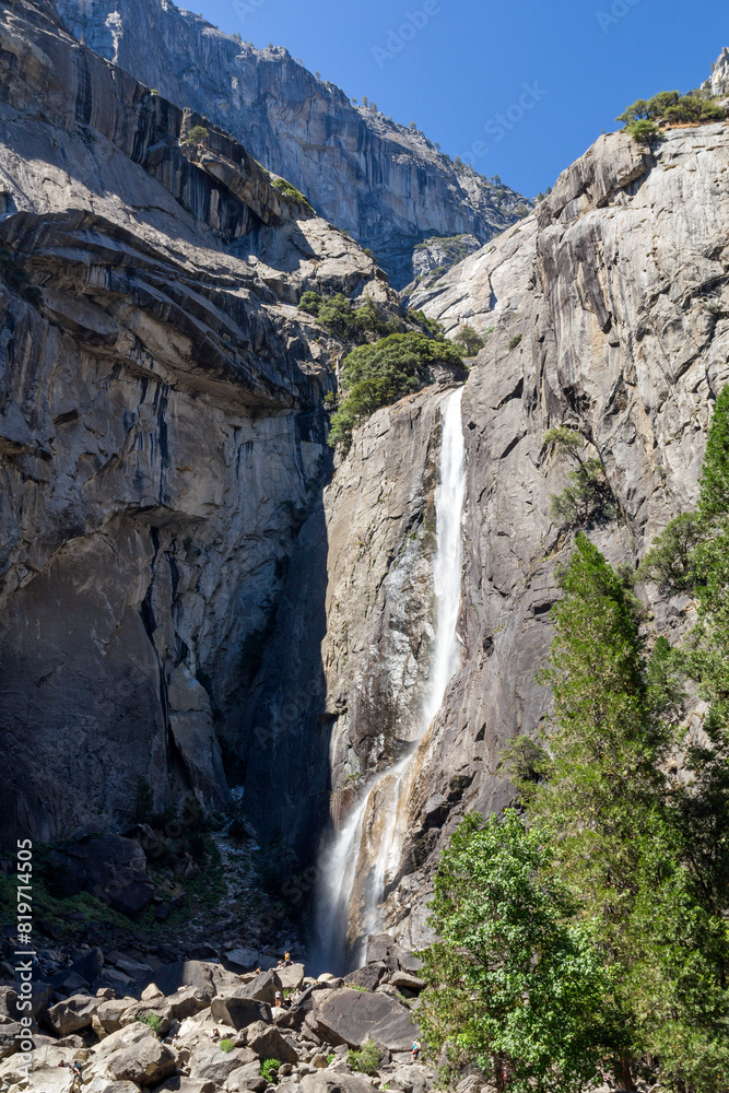 view through the trees to the famous lower Yosemite fall from below at the Yosemite national park view through the trees to the famous lower Yosemite fall from below at the Yosemite national park