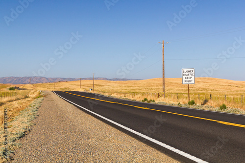 an beautiful, iconic and dreamy state road at the golden our CA-140 at catheys Valley, California. With a traffic sign which tells slower traffic keep right  photo