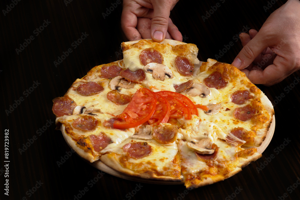 Pizza with mozzarella cheese, ham and mushrooms on wooden table Pizza with mozzarella cheese, ham and mushrooms on wooden table