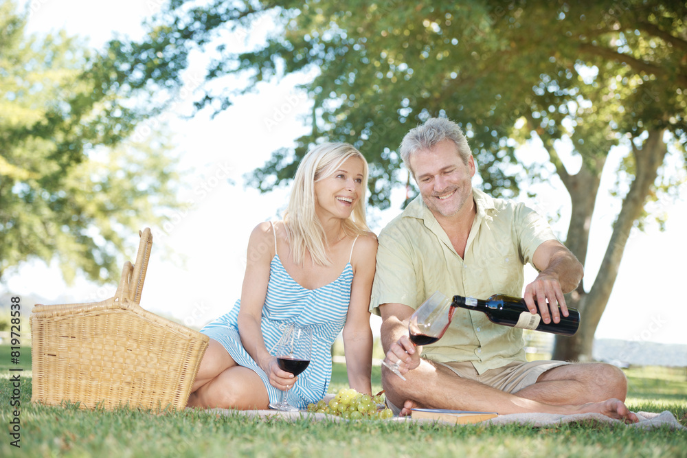 Happy, couple and red wine with basket on picnic for anniversary, holiday and adventure together. Man, woman and smile with glass at countryside for marriage, love or romantic vacation in New Zealand Happy, couple and red wine with basket on picnic for anniversary, holiday and adventure together. Man, woman and smile with glass at countryside for marriage, love or romantic vacation in New Zealand
