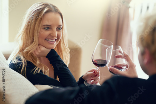 Couple  wine and happy with cheers on sofa for celebration  anniversary date and bonding in living room of home. People  drinking alcohol or relax on couch with toast to achievement  success or smile