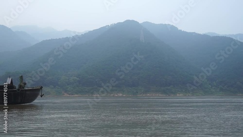 Aerial view boat sailing on river surrounded by dense trees photo