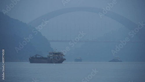 Aerial view boat sailing on river surrounded by dense trees photo