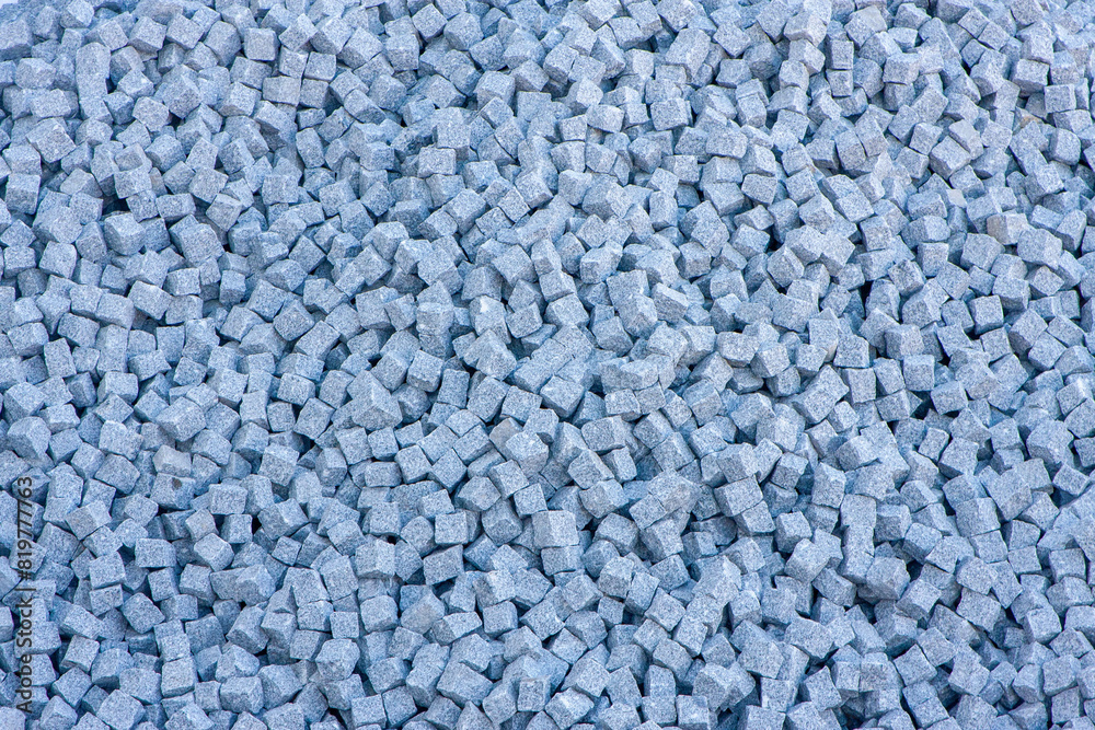 Stacked granite blocks, neatly arranged for paving. Perfect for construction, architecture, and urban design concepts.