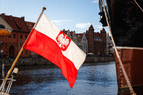 Polish flag with national coat of arms used as a naval ensign of Poland. Port in the Gdansk city, Baltic sea travel destination © encierro