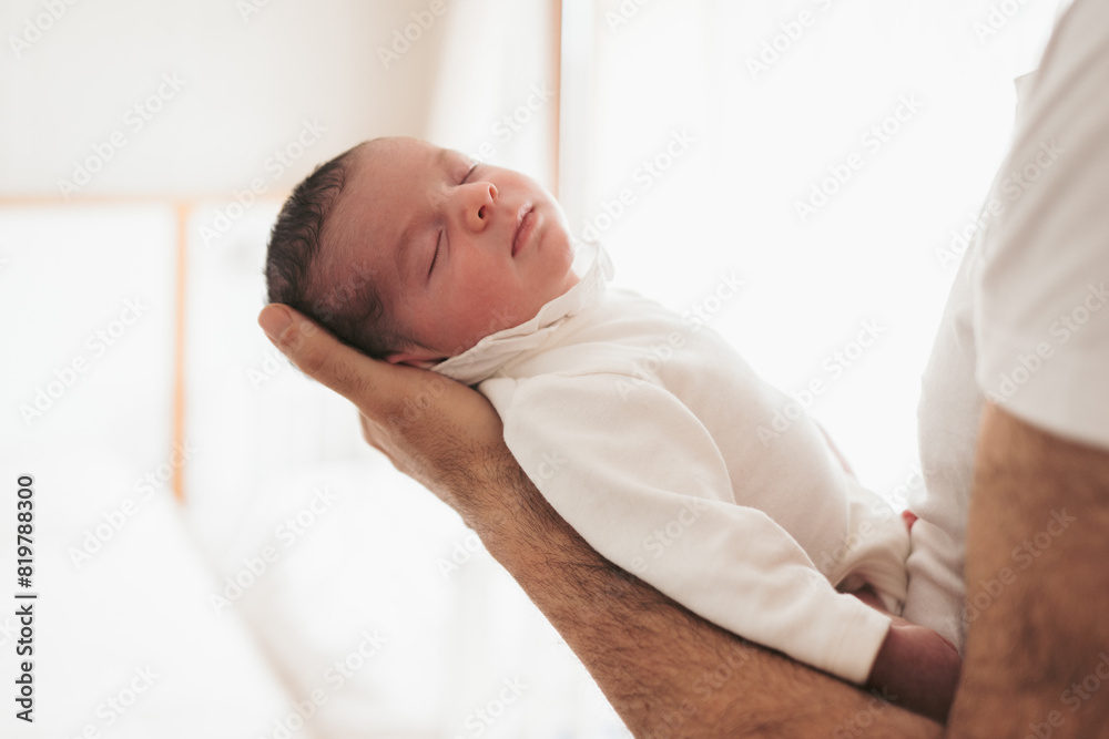 Newborn baby sleeping peacefully in parent's hands Newborn baby sleeping peacefully in parent's hands