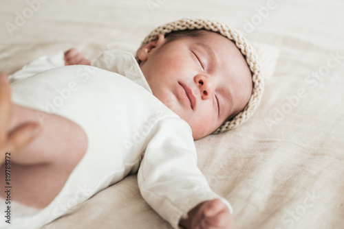 Peaceful newborN sleeping soundly in a knit cap photo