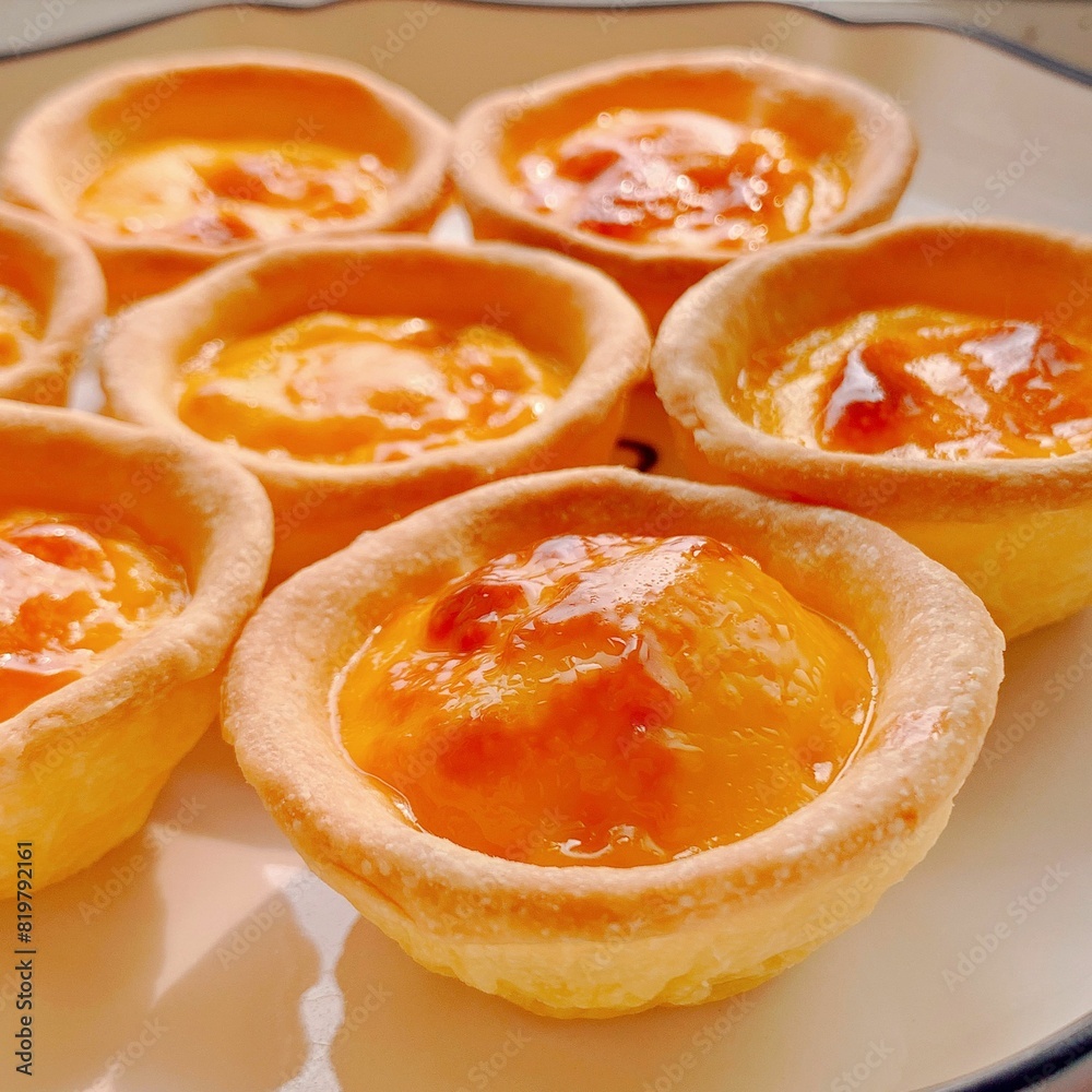 Closeup shot of delicious homemade egg tarts on baking tray