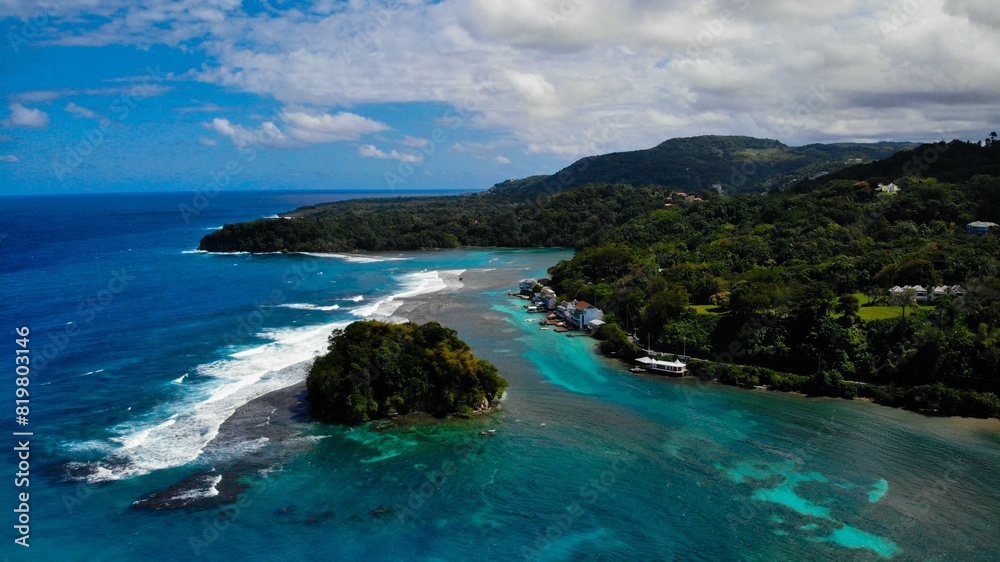 Breathtaking aerial shot of a stunning island situated in a tranquil blue body of water Breathtaking aerial shot of a stunning island situated in a tranquil blue body of water