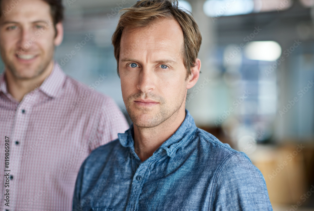 Business man, serious and portrait at startup with colleagues, team or confident in career at modern office. Person, employees and ready for job with professional, friends and creative media agency