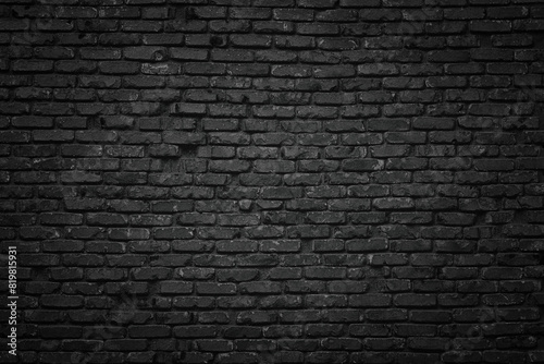 old blackened brick wall background, dark texture of rough brickwork