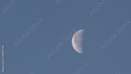Half moon on blue sky during daylight.