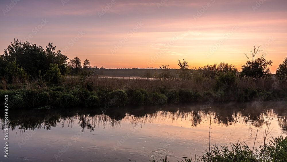 Sunrise over the Suprasl River at the boulevard in Suprasl. Sunrise over the Suprasl River at the boulevard in Suprasl.