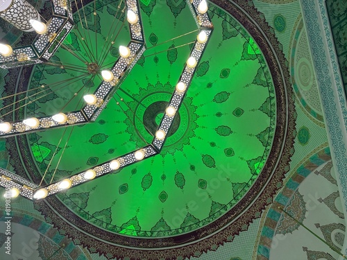 green light reflected from the inside to the mosque dome