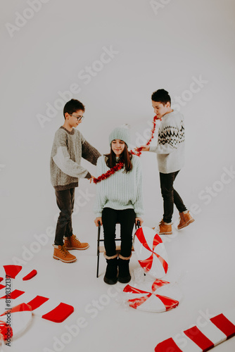 Christmas Kid Joy: Brothers and Sister Smiling and Having Fun for Christmas photo