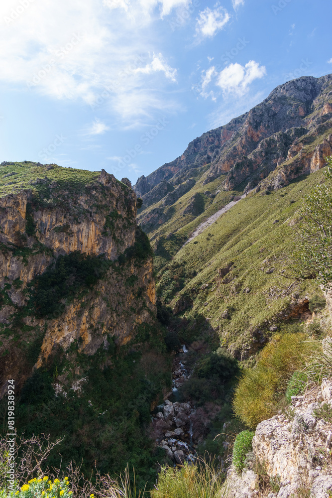 View of Rock with canyon and small creek at the Madonie Natural Park on a sunny day, Isnello, Sicily, Italy View of Rock with canyon and small creek at the Madonie Natural Park on a sunny day, Isnello, Sicily, Italy