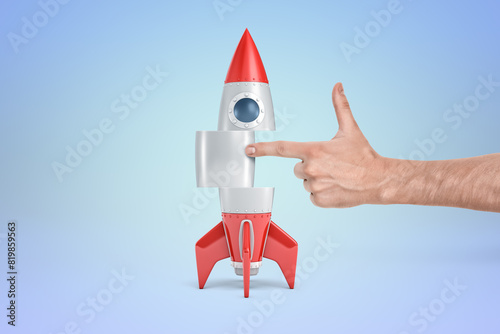 Bilde på lerret Hand points at rocket suggesting launch