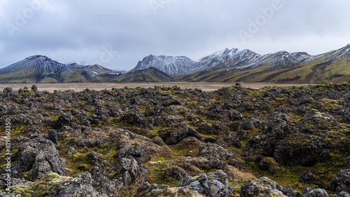 Rugged lava fields and snowy peaks in Icelandic Highlands photo