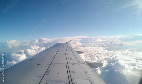 Majestic airplane wing with a beautiful background of sky and clouds.