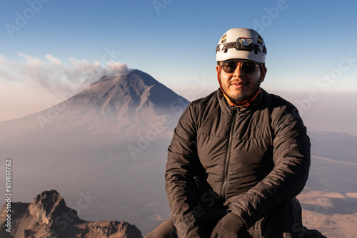 Hiker overlooking Popocatepetl volcano from Iztaccihuatl