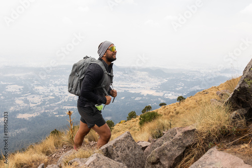 Determined hiker training on a mountain trail photo