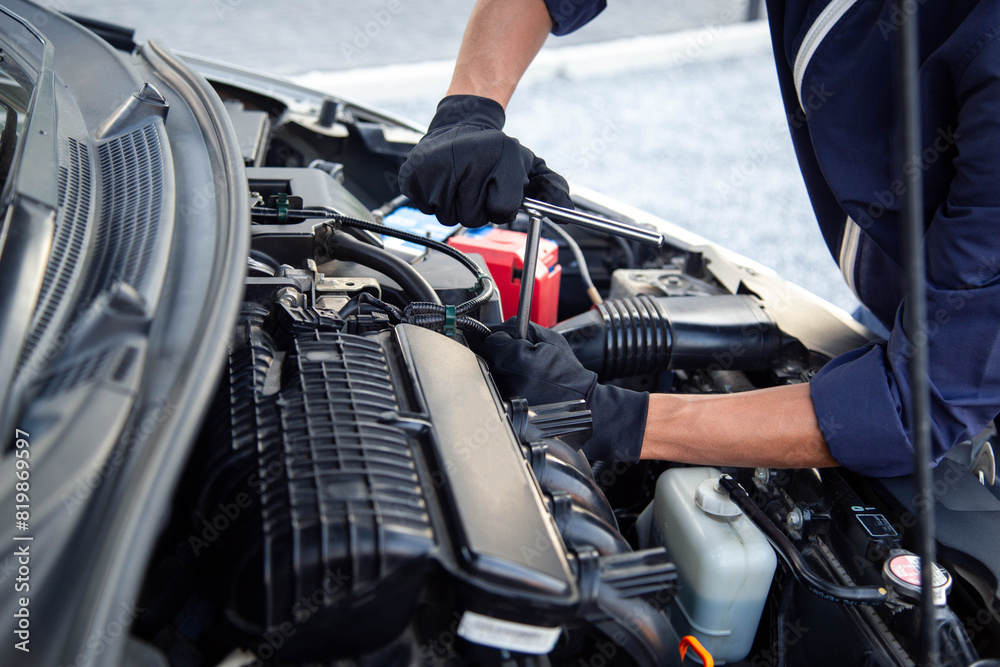 Professional mechanic working on the engine , repairing a car engine automotive workshop with a wrench, car service and maintenance,Repair service. Professional mechanic working on the engine , repairing a car engine automotive workshop with a wrench, car service and maintenance,Repair service.