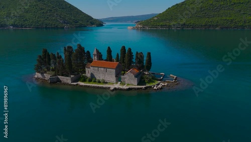 The unique island of St. George and the Church of Gospa od Škrpela (Madonna on the Reef). Bay of Kotor, Perast, Montenegro. Amazing mountain landscape. Beautiful Bay of Kotor. Drone video, 4k. photo