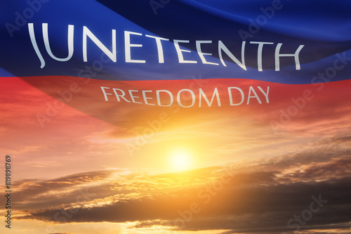 Fluttering banner with text Juneteenth Freedom Day on the wind on background of sunrise or sunset. Since 1865.
