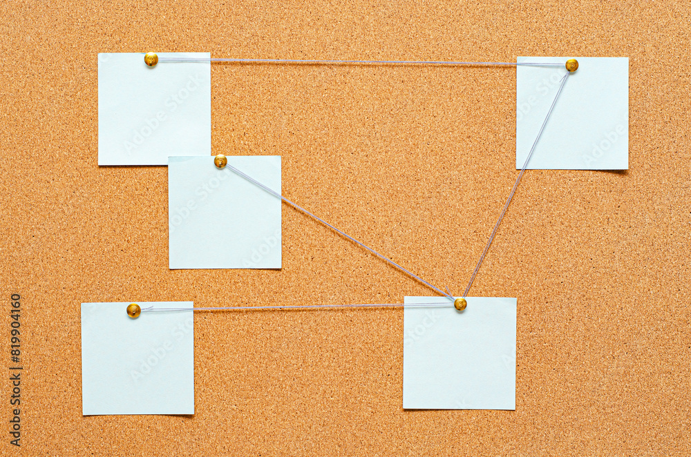 Blank paper notes are pinned to a cork board. The concept of detective investigation or training. Copy space. Blank paper notes are pinned to a cork board. The concept of detective investigation or training. Copy space.