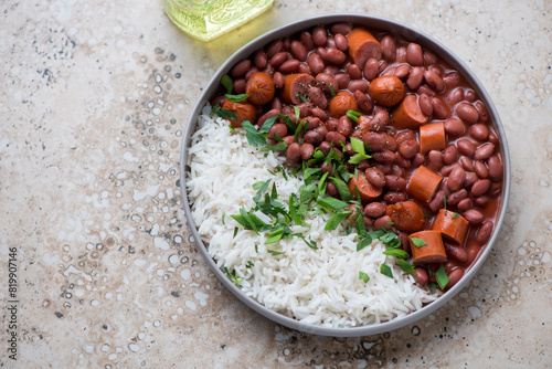 Plate with red beans and white rice on a beige granite background, horizontal shot with space, high angle view