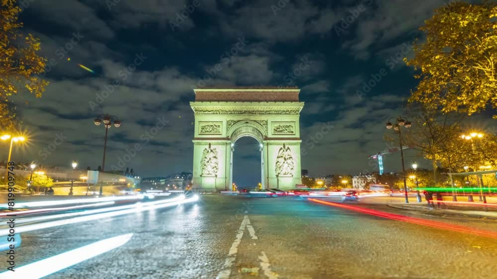 4K Timelapse of traffic at Arc de Triomph at night. This historical monument overlooks the avenue des champs élysées in the heart of Paris, French capital.