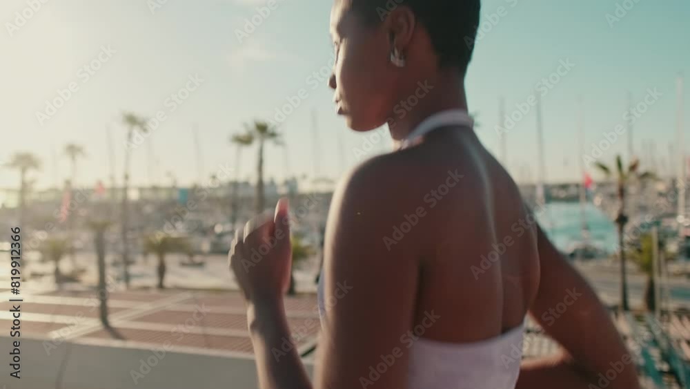 Close-up of a fit girl in sportswear doing street workout, running along the sea Close-up of a fit girl in sportswear doing street workout, running along the sea