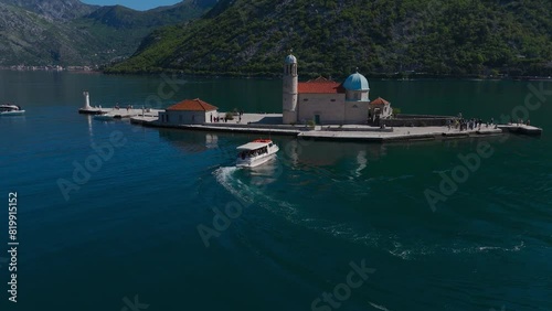 The Church of Gospa od Škrpela (Madonna on the Reef). Bay of Kotor, Perast, Montenegro. Amazing mountain landscape. Beautiful Bay of Kotor. Drone video, 4k. photo