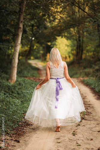 Beautiful blonde lady woman in white dress outdoors © stivog