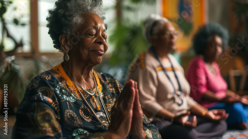 Senior black woman meditating together on wellness spa retreat. Retired elderly african american female pensioners practicing yoga meditation   deep breathing exercises for mental health   anxiety