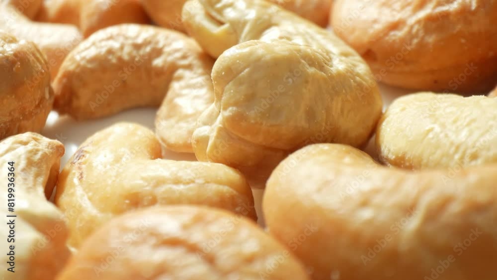 Golden-brown cashew nuts, uniformly roasted, boast a wrinkled texture hinting at their perfectly cooked state. Each nut promises a delightful crunch and a rich, nutty flavor.
Golden-brown cashew nuts, uniformly roasted, boast a wrinkled texture hinting at their perfectly cooked state. Each nut promises a delightful crunch and a rich, nutty flavor.