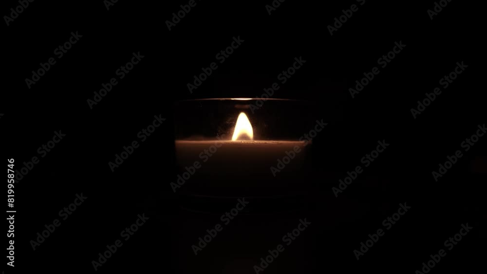 Candle light in the dark in church. Flickering Candle. Spiritual Atmosphere Candle light in the dark in church. Flickering Candle. Spiritual Atmosphere