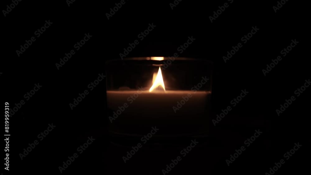 Candle light in the dark in church. Flickering Candle. Spiritual Atmosphere Candle light in the dark in church. Flickering Candle. Spiritual Atmosphere