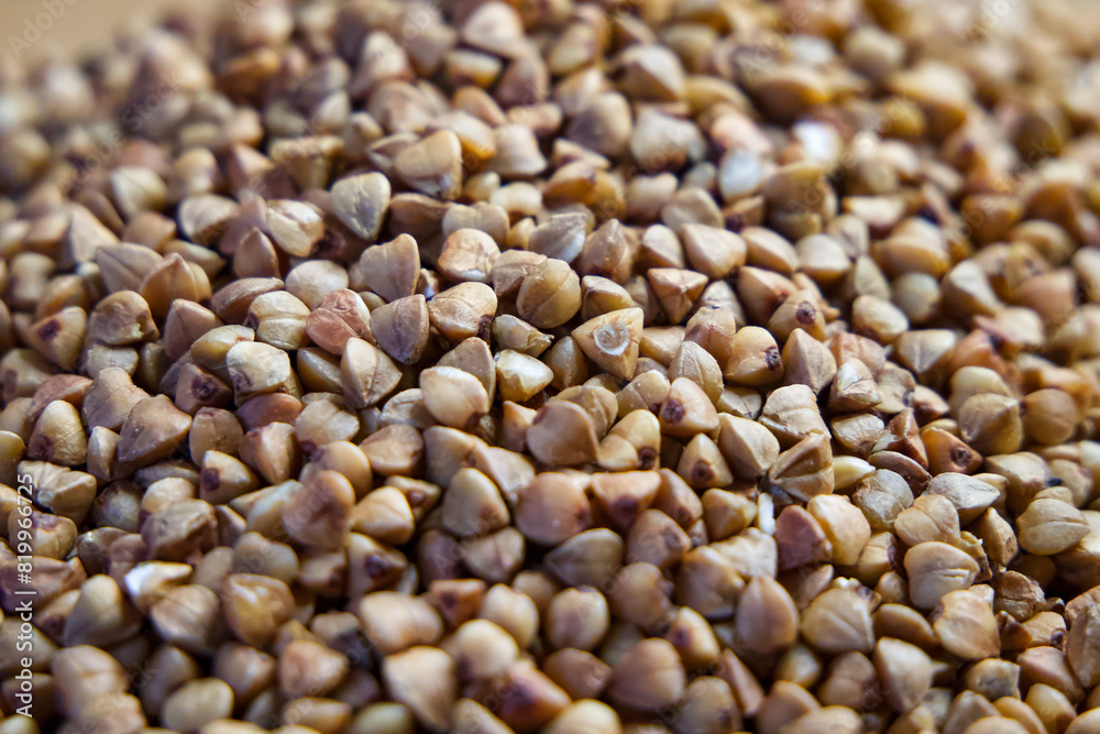 Raw Buckwheat Pile. Buckwheat grains filling the frame, perfect for culinary and health themes.