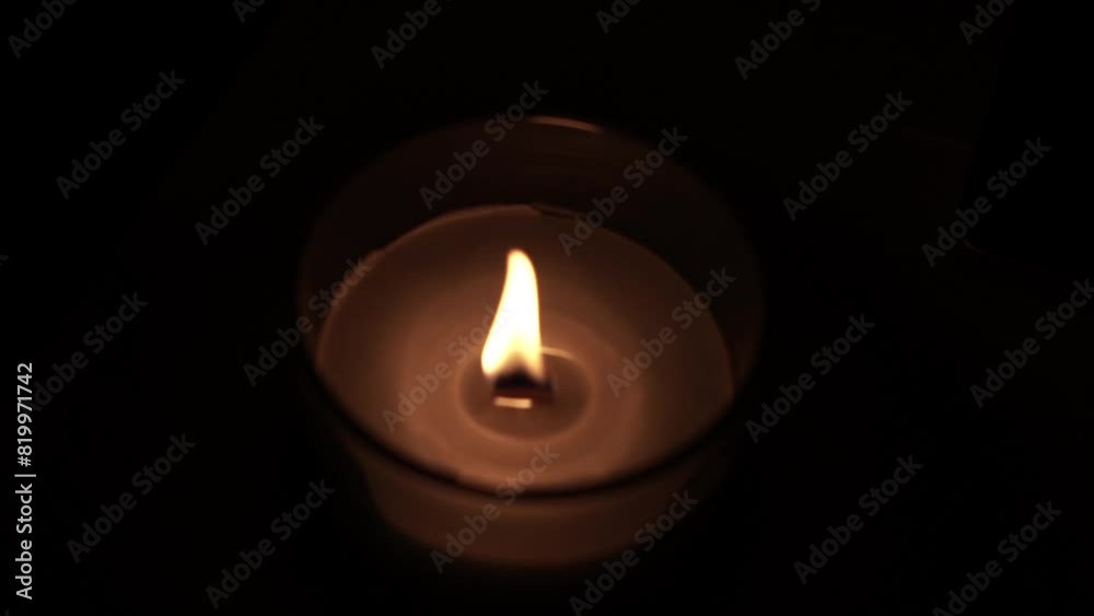 Candle light in the dark in church. Flickering Candle. Spiritual Atmosphere Candle light in the dark in church. Flickering Candle. Spiritual Atmosphere