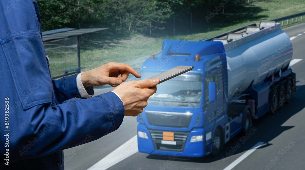 Manager with a digital tablet on the background of truck. Fleet management.. Manager with a digital tablet on the background of truck. Fleet management..